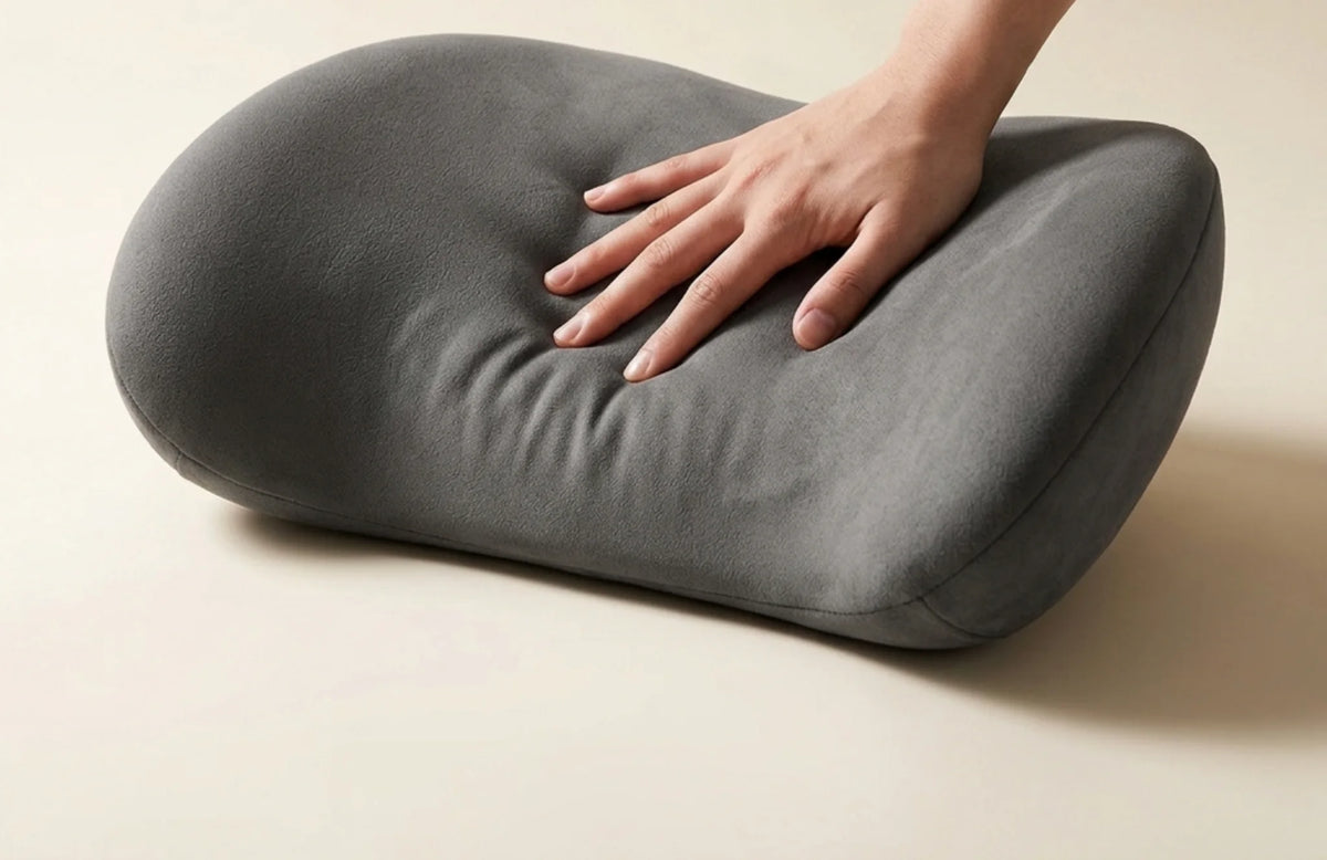 Hand pressing into the slow-rebound memory foam